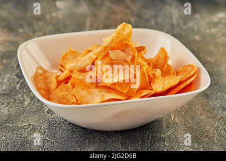 Sweet potato chips in white plate are ready to be eaten. Stock Photo
