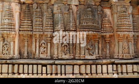 Sculptures of Hindu Gods and Goddesses under Aedicules or shrines in shape of vimanas on the Temple of Panchalingeshwara Temple, Govindanahalli, Mandy Stock Photo