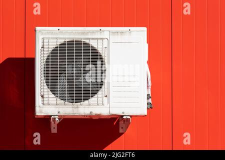 outdoor air conditioner unit on the wall of a building Stock Photo