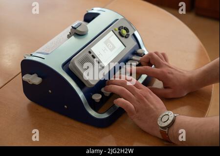 Blind man using braille typewriter.  Stock Photo