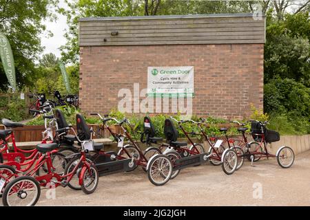 Tunstall , Stoke on Trent united kingdom  May 27 2022  red Two-seater Four-wheel tourist tandem bicycle's parked in a line waiting to be hired Stock Photo