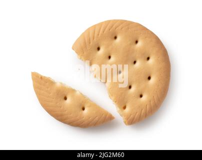 Broken biscuit placed on white background. Viewed from directly above. Stock Photo