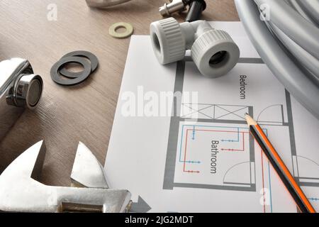 Plumbing reform in homes with material and tools on wooden table.. Top view. Horizontal composition. Stock Photo