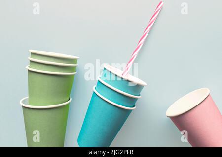 Close-up of paper cups with drinking straw, isolated on light blue background Stock Photo