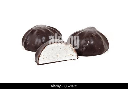 Close-up shot of whole marshmallows and one half covered with chocolate isolated on white background. Yummy mini dessert, closeup Stock Photo