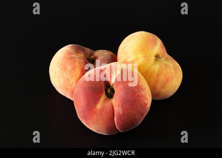 Three ripe fig peaches on black background Stock Photo
