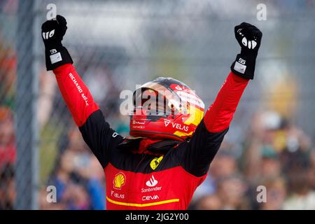 Carlos Sainz celebrates winning his first ever F1 Grand Prix standing on top of his car in Parc ferme at the F1 British Grand Prix. Carlos Sainz wins Stock Photo