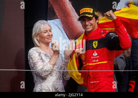 Carlos Sainz celebrates winning his first ever F1 Grand Prix as Nadine Dorries looks on on the podium at the F1 British Grand Prix. Carlos Sainz wins Stock Photo