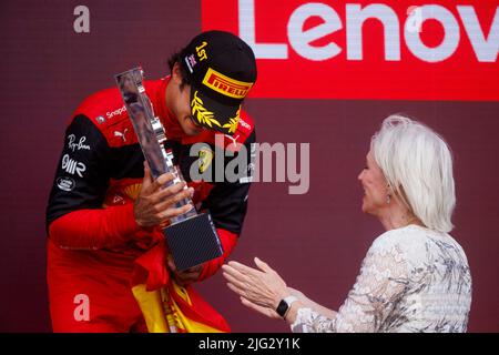 Carlos Sainz celebrates winning his first ever F1 Grand Prix as Nadine Dorries hands him the trophy on the podium at the F1 British Grand Prix. Carlos Stock Photo