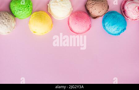 Colorful ice cream scoops on pink background with place for text. Copy space. Stock Photo