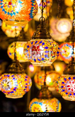 Traditional handmade multicolor Turkish, Moroccan, Arabian lamps hanging with nice blurred background. Mosaic style and colored glass lantern. Stock Photo
