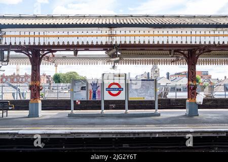 London- June 2022: Ravenscourt Park underground station sign Hammersmith, West London Stock Photo
