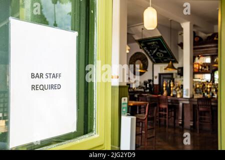Job advert for Bar Staff on entrance of British public house Stock Photo