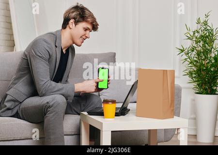 Handsome caucasian young man using phone at home Stock Photo
