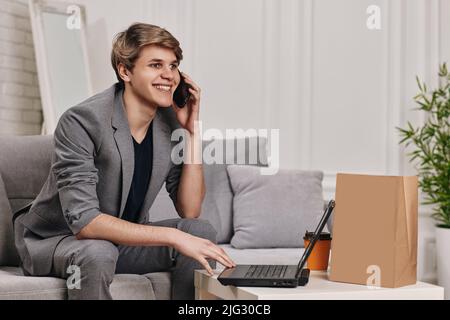 man sit on the couch and shopping in internet stores Stock Photo