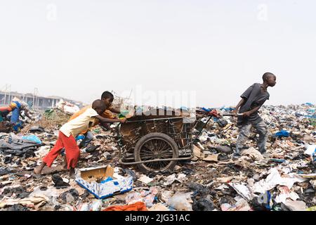 People at a landfill site in West Africa recycling household and industrial waste Stock Photo