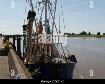 Fishing boat moored at the quay side of Great Ouse River in King's Lynn port Norfolk England UK on lovely June day with blue sky Stock Photo