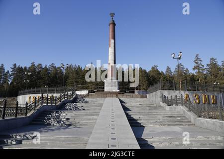 Monumental obelisk on the border between Europe and Asia in a forest near Ekaterinburg, Russia Stock Photo