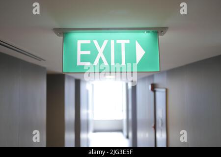 Fire exit sign in the middle of the the corridor in building Stock Photo