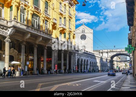Street view of Via XX Settembre in the city centre with the Church of St Stephen and the Monumental Bridge, Genoa, Liguria, Italy Stock Photo