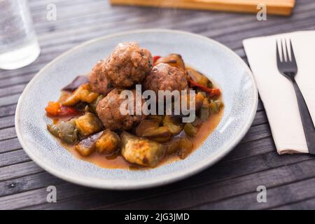 cooked meatballs with stewed eggplant with haze in bowl Stock Photo