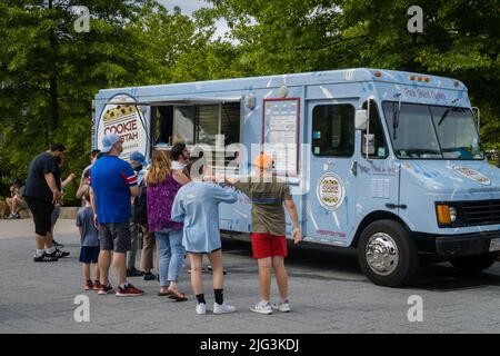 Boston, MA, US-June 11, 2022: People lined up at food truck on a summer day in downtown neighborhood. Stock Photo