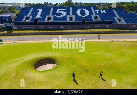 St Andrews, Scotland, UK. 7 July 2022. The Old Course at St Andrews is a hive of activity with one week to go until the first round of the 150th Open championship. Members of the public are allowed to walk the fairways because  the Old Course is a public park. Tourists made the most of this access to pose for photographs beside famous features such as the Swilken Burn bridge on the 18th hole. Pic; view of famous Road Hole - the 17th hole.  Iain Masterton/Alamy Live News Stock Photo