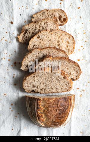 Sliced bread on a white linen tablecloth Stock Photo