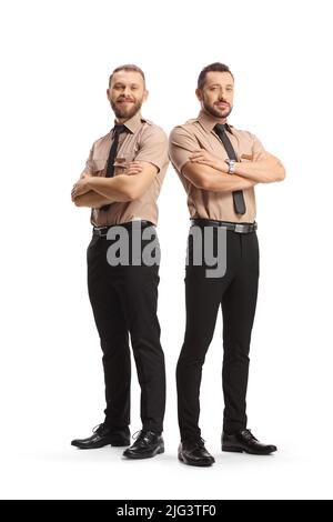 Full length portrait of two security guards posing with crossed arms isolated on white background Stock Photo