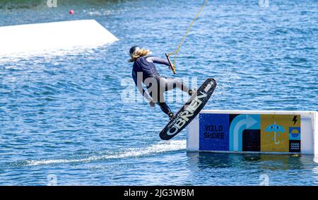 Dundee, Tayside, Scotland, UK. 7th July, 2022. UK Weather: The hottest day of the year in Dundee with temperatures reaching 24°C across North East Scotland. Wakeboarders from Wild Shore Water sports activities enjoy a warm sunny July day wakeboarding on a rail at Dundee's City Quay's West Victoria Dock. Credit: Dundee Photographics/17�Թ����� Live News Stock Photo
