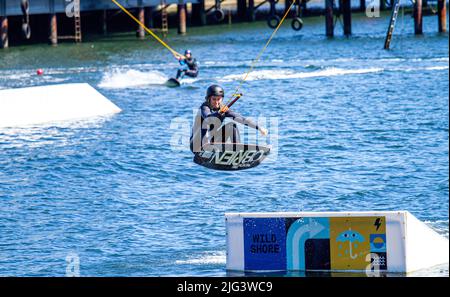 Dundee, Tayside, Scotland, UK. 7th July, 2022. UK Weather: The hottest day of the year in Dundee with temperatures reaching 24°C across North East Scotland. Wakeboarders from Wild Shore Water sports activities enjoy a warm sunny July day wakeboarding on a rail at Dundee's City Quay's West Victoria Dock. Credit: Dundee Photographics/17�Թ����� Live News Stock Photo