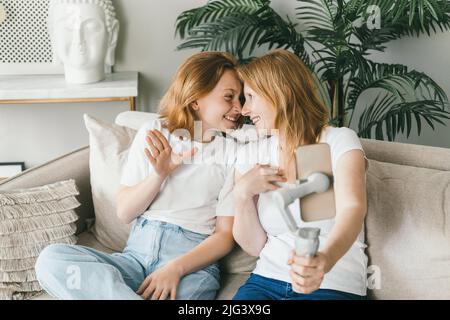 The teenage girl pressed her forehead against her mother's face.  Stock Photo