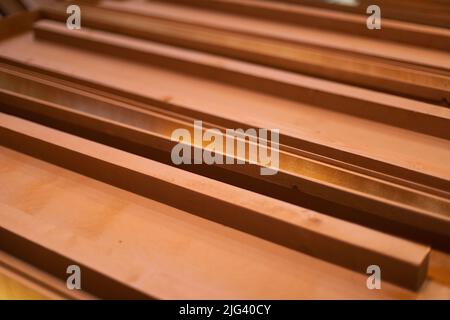 Brown boxes made of wood. Boards in carpentry workshop. Manufacture of furniture. Brown board. Stock Photo