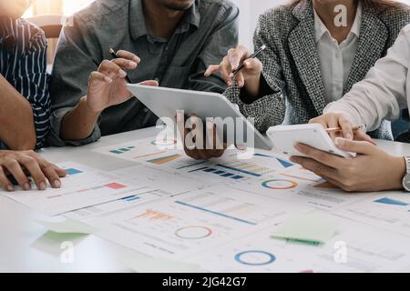 Achieving best results together. Close up of young business people discussing project while working in the office Stock Photo