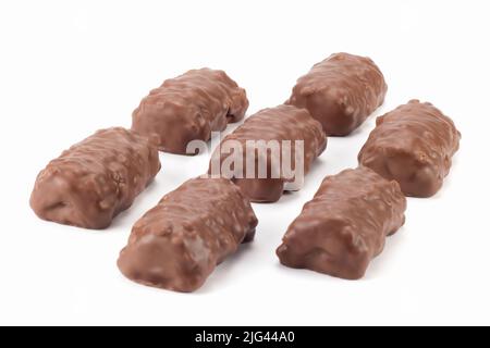 Arranged crispy bits of chocolate bars. Chocolate bars with peanuts and caramel. Close up view. Stock Photo