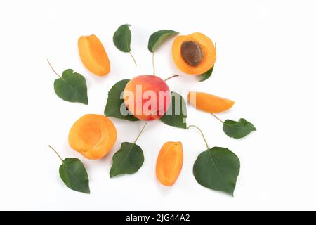 Fresh Apricot fruits isolated on bright background, sliced and whole. Top view. Stock Photo