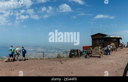 Naples, Italy. May 28, 2022. Panorama from Mount Vesuvius with Souvenir shop and tourists on top and city of Naples in the background. Stock Photo