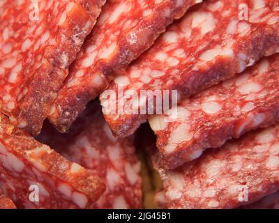 Smoked sausage, full frame. Pieces of appetizing meat snack close-up. Salami Background, meat delicatessen Stock Photo