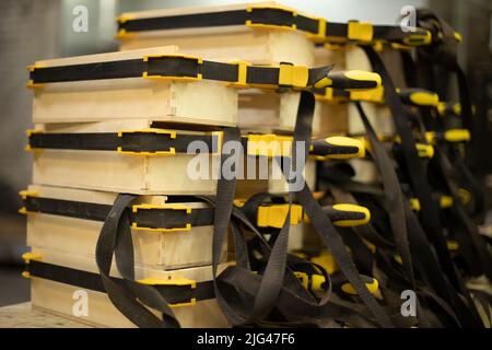 Tightening boards. Tool for fixing parts. Straps are black. Wooden boxes are glued together. Stock Photo