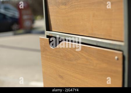 Wooden cabinet for waste. Garbage closet. Stock Photo