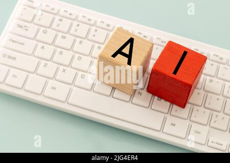 The word AI, artificial intelligence on wooden blocks and a computer keyboard, The concept of modern technological development Stock Photo