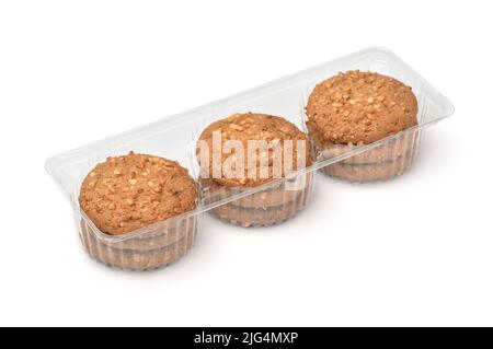 Oatmeal cookies with nut crumbs in transparent retail plastic tray isolated on white Stock Photo