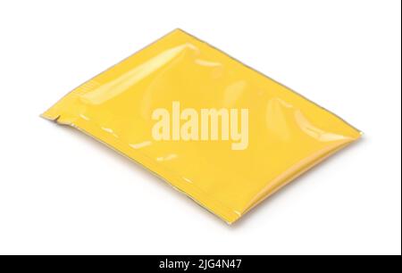 Yellow blank foil packaging sachet bag isolated on white Stock Photo