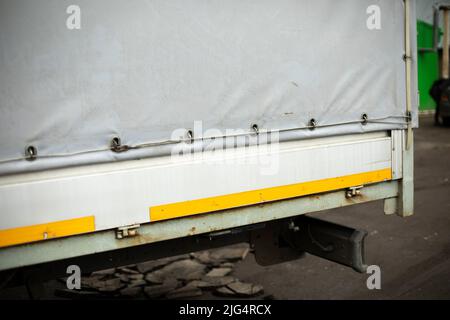 Truck body parts. Awning is tapped over trailer. Truck close-up. Stock Photo