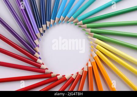 Colored pencils in acircle closeup. Colored pencils lie around on a white background Stock Photo