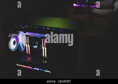 A gamer woman is working on her computer. Stock Photo