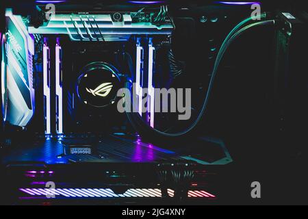 A high end gaming computer is illuminated with rainbow colors. All hardware components are shining in in different colors. Stock Photo