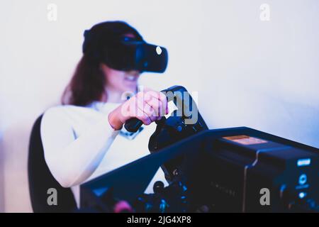 A gamer woman is sim racing with a high end simracing reck Stock Photo