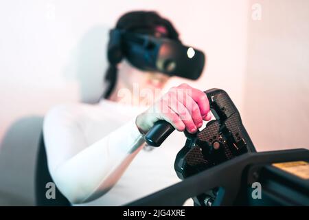 A gamer woman is sim racing with a high end simracing reck Stock Photo