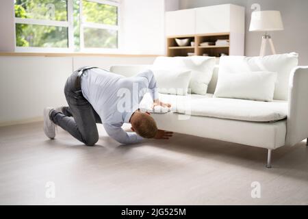 Man Looking For Lost Keys Or Searching Something Stock Photo